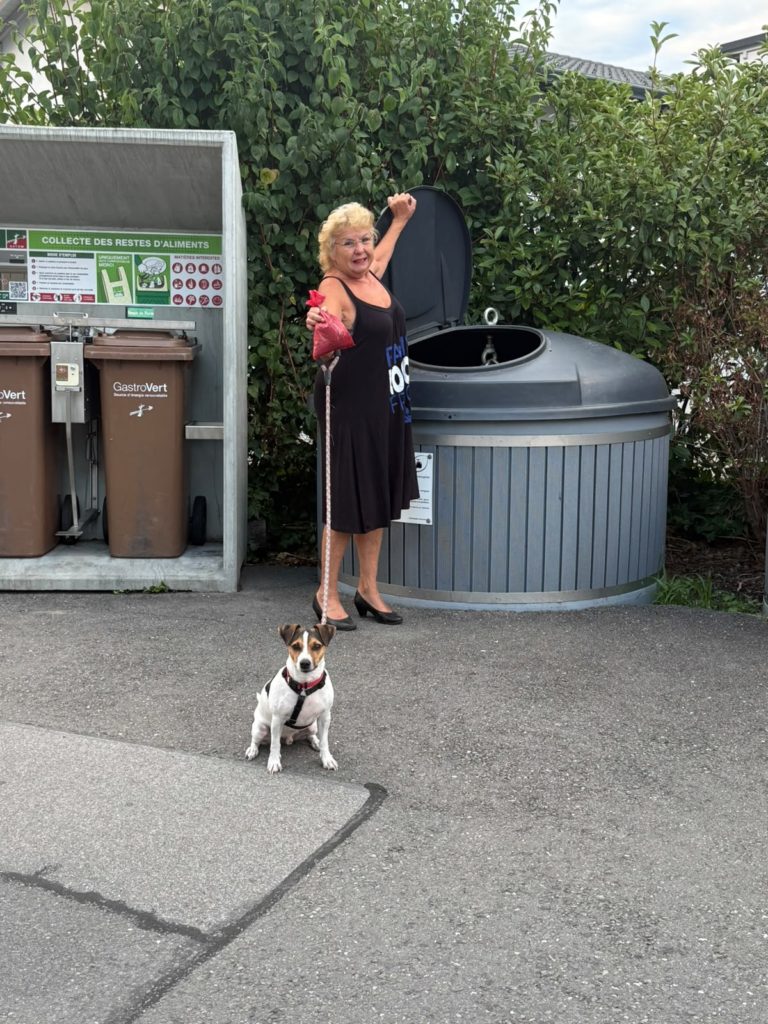 photo d'une dame jettant le sac à crottes dans le molok